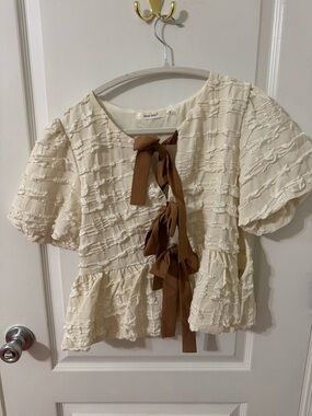 Textured Cream Peplum Blouse with Brown Tie Accents
